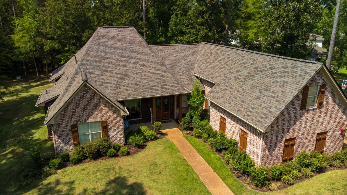 A suburban home with freshly installed roof shingles